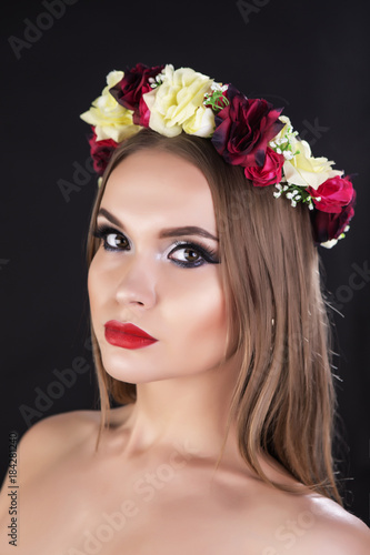 Russian beauty, portrait of a brunette girl wearing crown made from roses