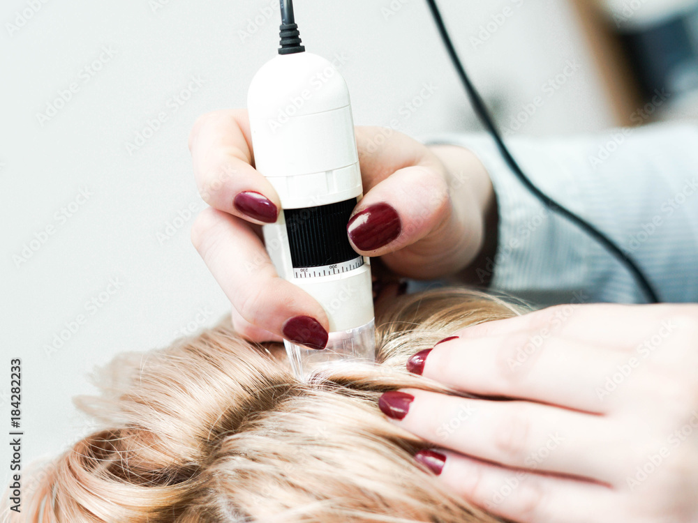 Hair doctor checking hair. Diagnostics hair and scalp.Trihoskopiya