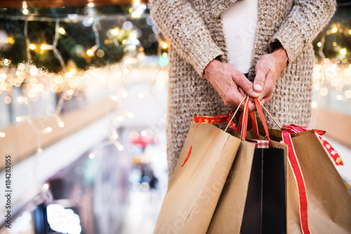 Senior woman with bags doing Christmas shopping.