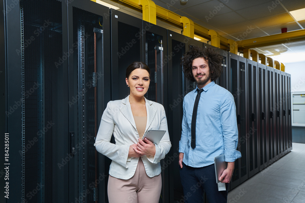 Young couple working at a data center Young couple working at a data center