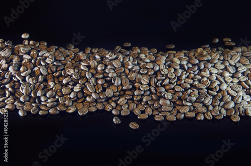 Coffey grains lying on a dark mirror surface
