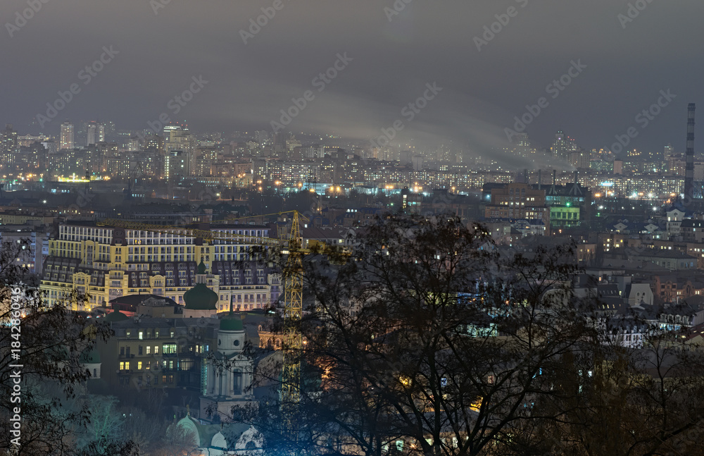 View of the ancient Podil district and modern Obolon district at background. Evening city panorama. Winter weekend evening. Kyiv, Ukraine