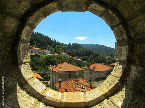 A view of a mountain village through an old fortress wall, Bulgaria.