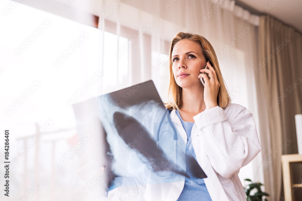 Female doctor with smartphone and x-ray. Female doctor with smartphone and x-ray.