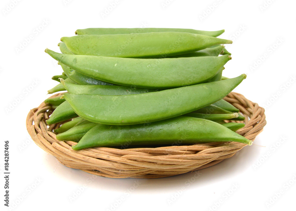 Pods of green peas sweet, isolated in basket on a white background Pods of green peas sweet, isolated in basket on a white background