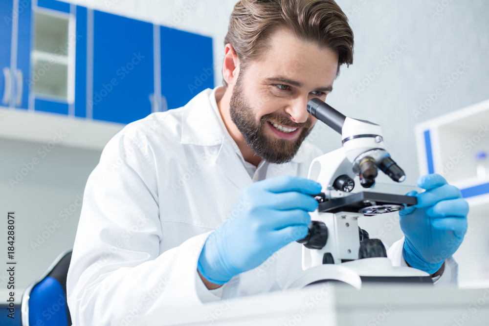 Cheerful positive scientist being happy with research results Cheerful positive scientist being happy with research results