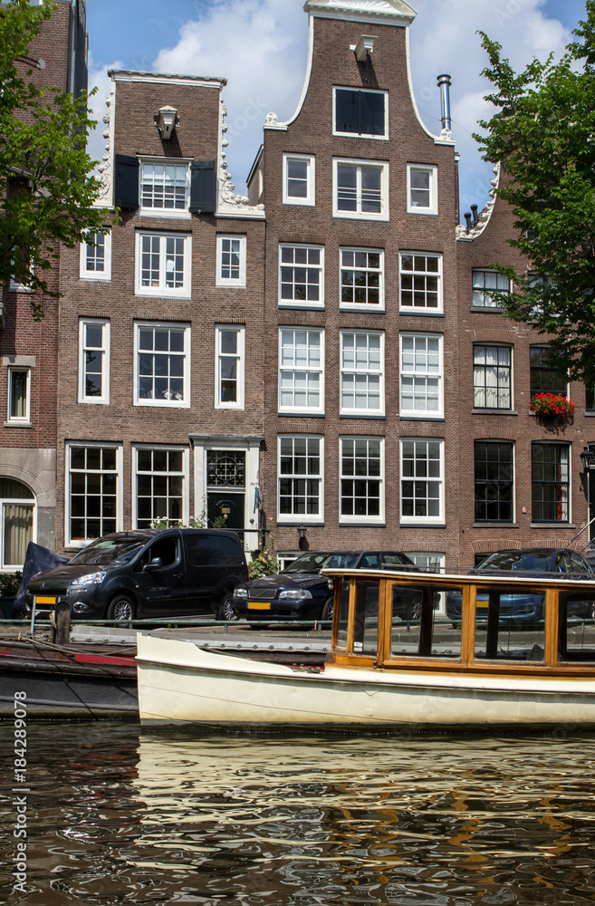 Naklejka premium Traditional old buildings in Amsterdam