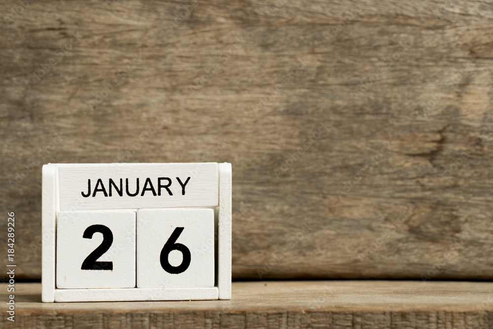 White block calendar present date 26 and month January on wood background White block calendar present date 26 and month January on wood background