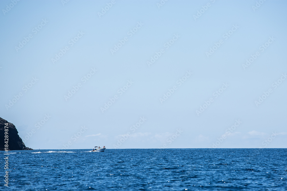 Small sportboat on atlantic ocean for island Small sportboat on atlantic ocean for island