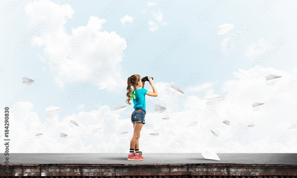 Concept of careless happy childhood with girl of school age looking in future Concept of careless happy childhood with girl of school age looking in future