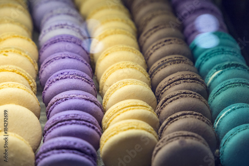 beautiful and tasty multi colored macarons under the shop window of the bakery confectionery shop