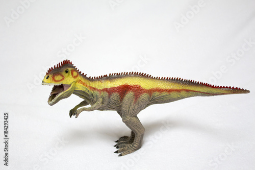 Tyrannosaurus toy isolated on white background. Dinosaur with open mouth.  close up of a plastic toy dinosaur.