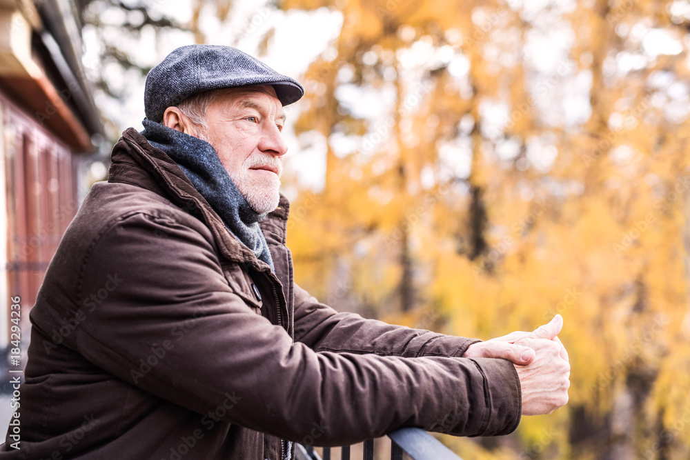 Senior man resting on a terrace in autumn nature. Senior man resting on a terrace in autumn nature.