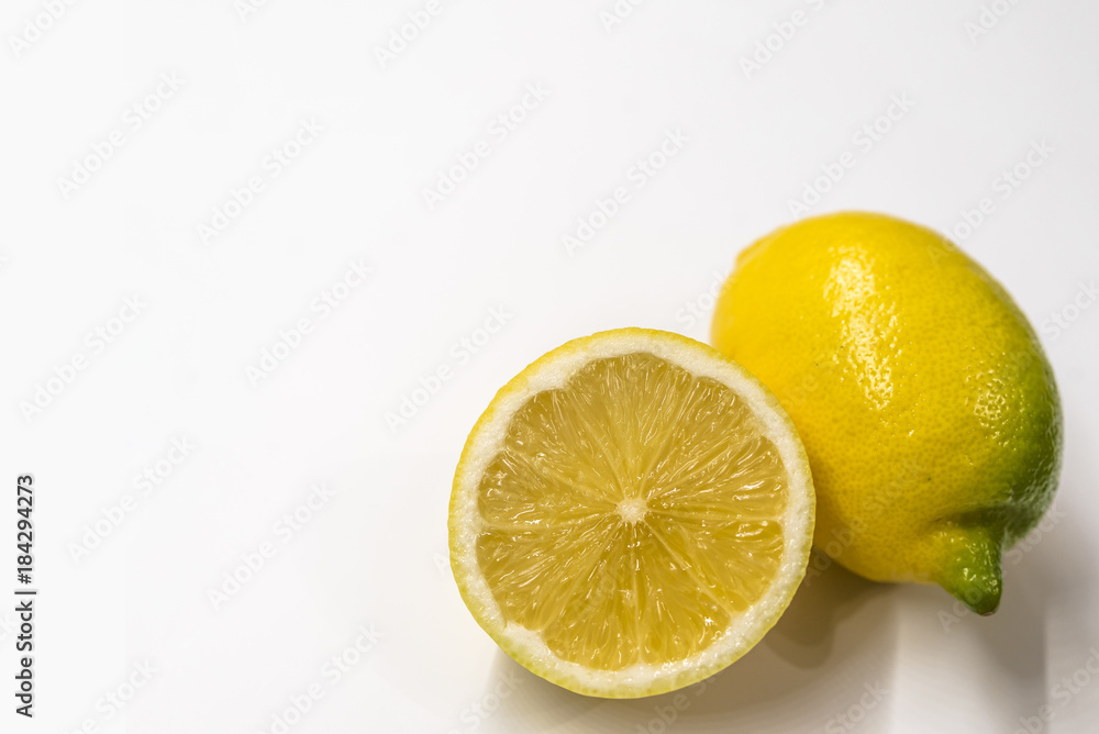 Textured ripe slice of lemon citrus fruit isolated on white background. Textured ripe slice of lemon citrus fruit isolated on white background.