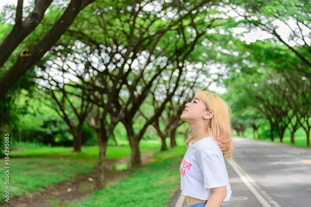 Portrait of asian young girl at tunnel trees,Beautiful thai woman take a photo outdoors,happy woman concept,she feeling fresh air Portrait of asian young girl at tunnel trees,Beautiful thai woman take a photo outdoors,happy woman concept,she feeling fresh air