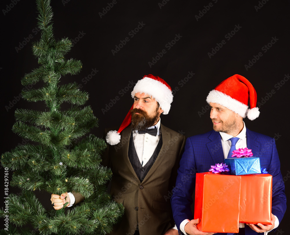 New Year corporate party concept. Businessmen install Christmas tree. New Year corporate party concept. Businessmen install Christmas tree.