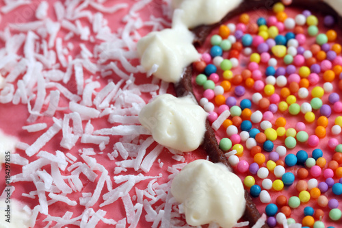 background of decorated with cream, coco and sprinkles heart shape strawberry souffle cake with copy space