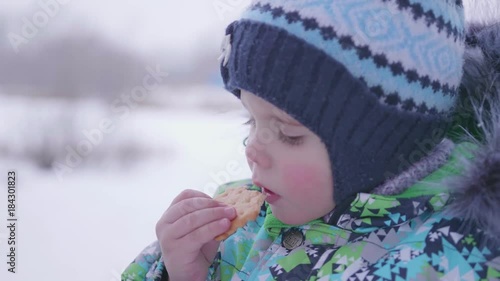 the child eats cookies winter outdoor
