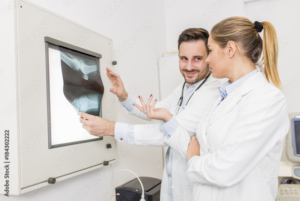 Doctors examining an x-ray of the patient Doctors examining an x-ray of the patient