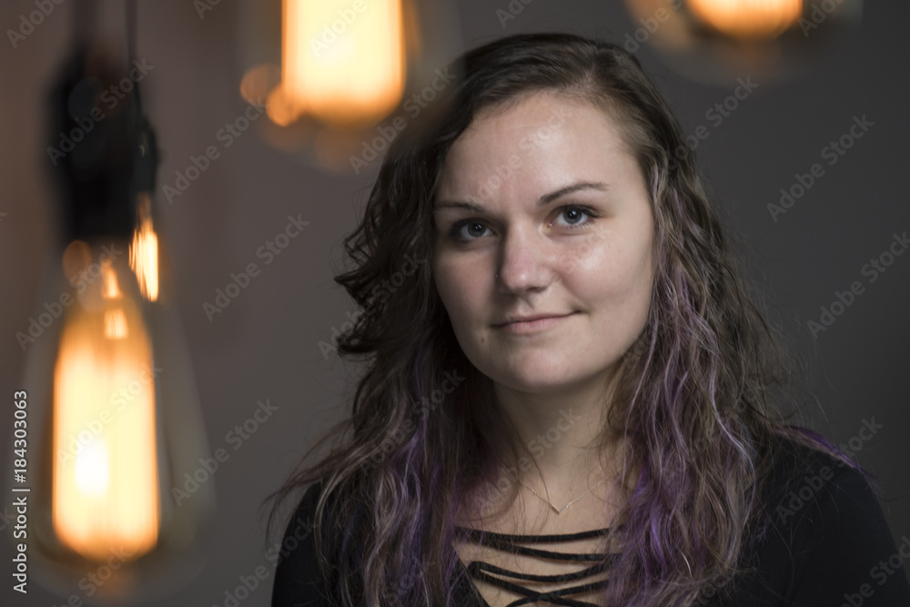Portrait of a young female smiling, looking at the camera Portrait of a young female smiling, looking at the camera