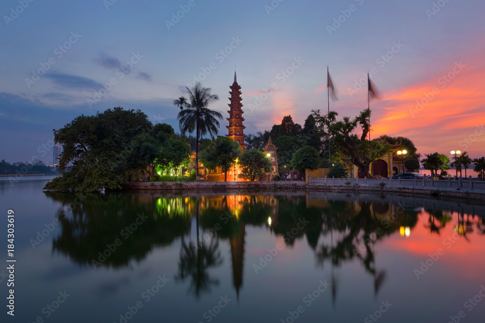 Tran Quoc Pagoda the oldest Buddhist temple in Hanoi, Vietnam. Located on a small island in West Lake with beautiful sunset