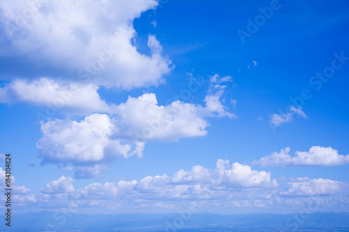 The white cloud on the blue sky in the bright day is suitable for being the nice background from the view of the highest point of Thailand. There are mountains being far at the below of the pic.