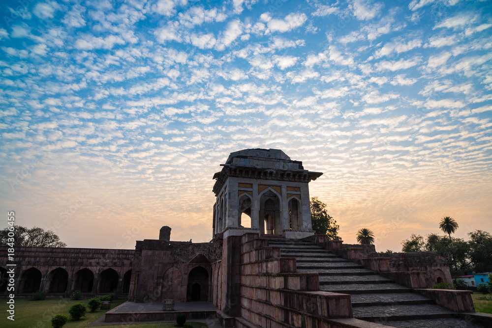Mandu India, afghan ruins of islam kingdom, mosque monument and muslim tomb. Colorful sky at sunrise. Mandu India, afghan ruins of islam kingdom, mosque monument and muslim tomb. Colorful sky at sunrise.