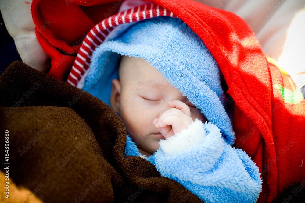 Dreamy little baby hidden in blue robe and red plaid Dreamy little baby hidden in blue robe and red plaid