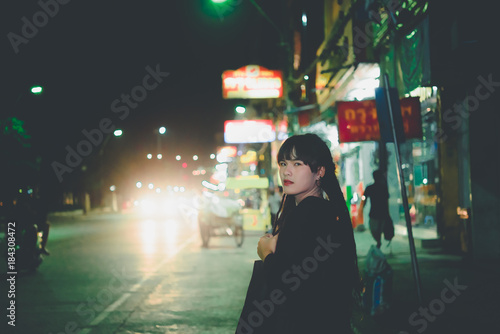 Portrait of asian woman hair dreadlock night scene in the city,Thailand people pose for take a photo,feeling lonely,sad woman concept