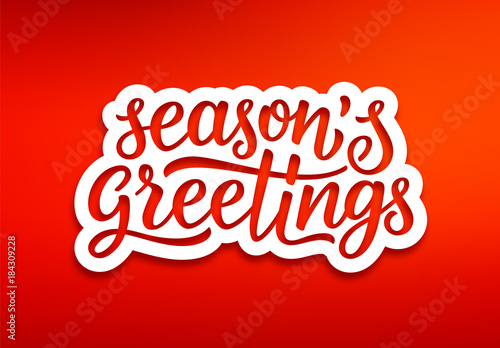 Seasons greetings text on white paper label with carving over red background. Modern calligraphy lettering on sticker for season greetings. Vector background photo