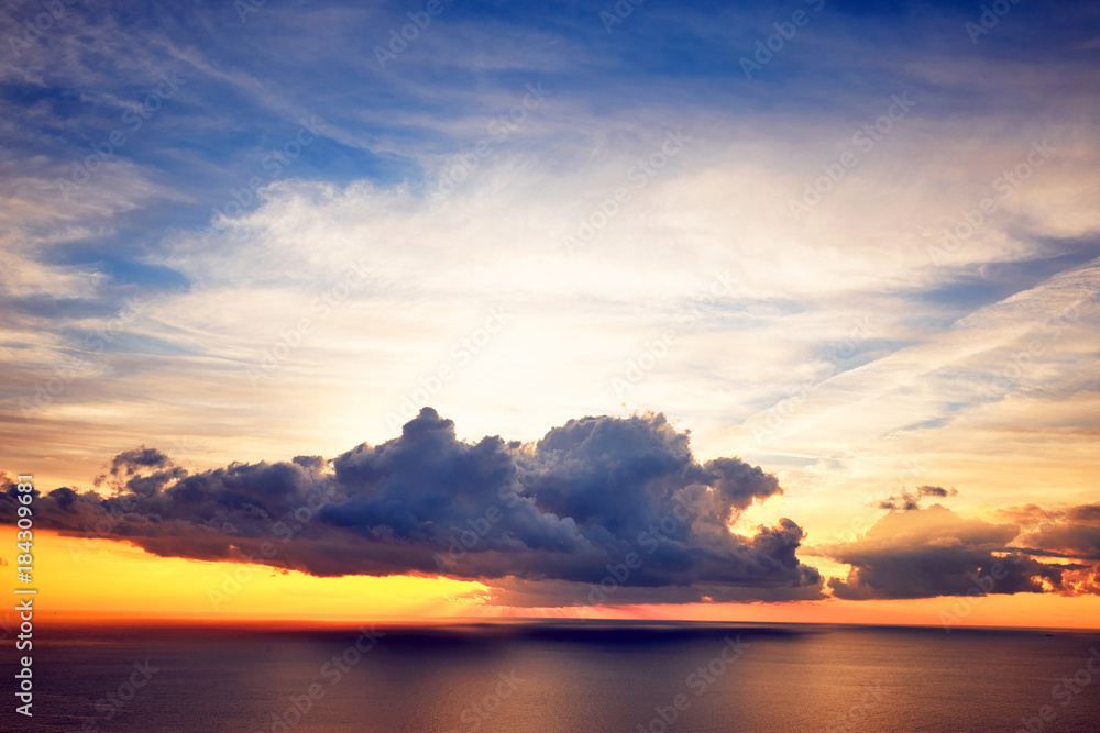 Sunset with a view of the sea with clouds.
