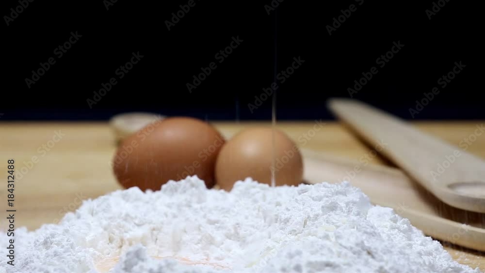 Flour for the dough on a wooden table Flour for the dough on a wooden table
