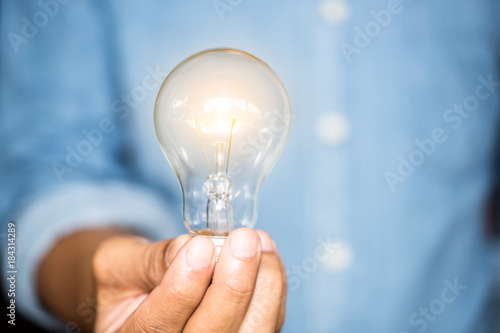 hand businesswoman holding light bulb, innovation and inspiration concept