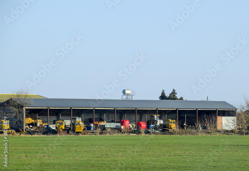 Tractors and other equipment under the awning in the garage. photo