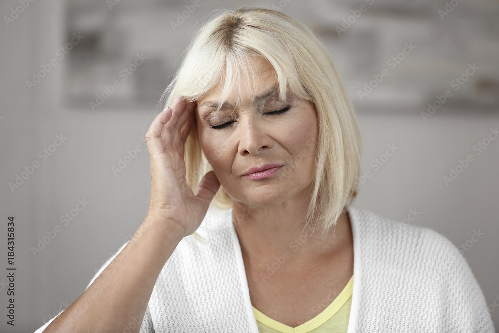 Mature woman having headache indoors Mature woman having headache indoors
