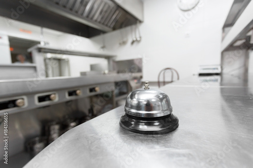 Alert bell on kitchen table in a restaurant photo