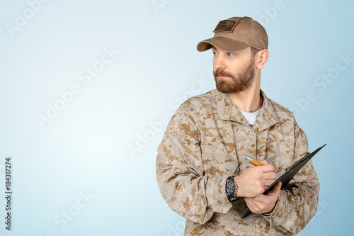 American soldier taking notes on clipboard