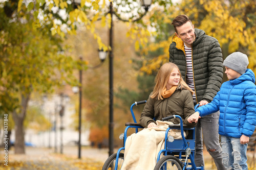 Teenage girl in wheelchair ...