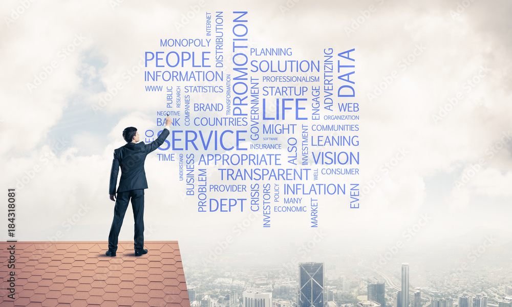 Young businessman standing on house roof and writing leadership Young businessman standing on house roof and writing leadership