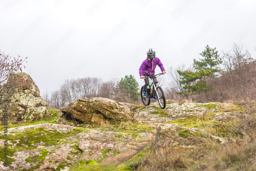 Enduro Cyclist Riding the Mountain Bike on the Rocky Trail.