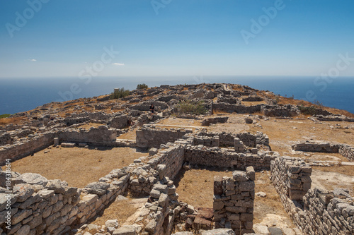 aerial view of the excavation site of Thira island with reflections of the sun on the sea's surface on behind
