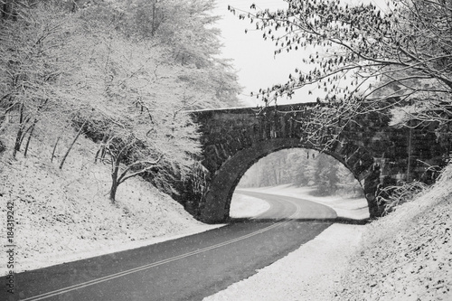 Scenic view of road passing through snowy landscape