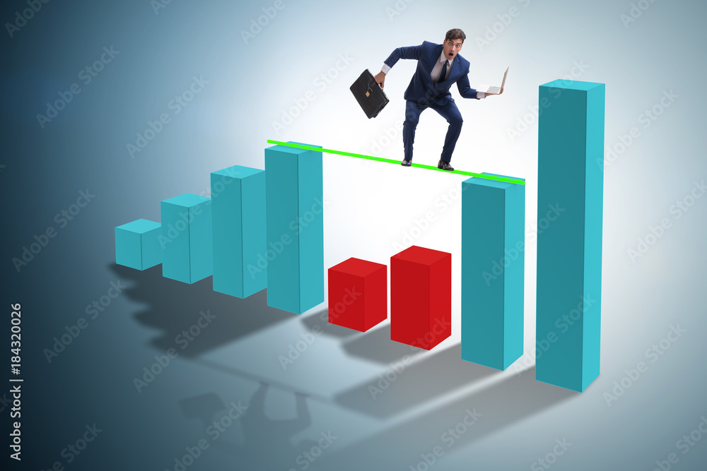 Young businessman in business concept with bar charts Young businessman in business concept with bar charts