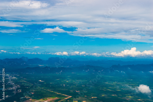 beautiful view of the fields, clouds and mountains from the airplane © kosmos111