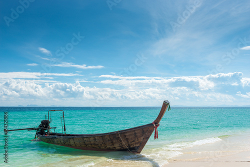 Poda Island, view of the wooden boat long tail from the sandy beach, Thailand