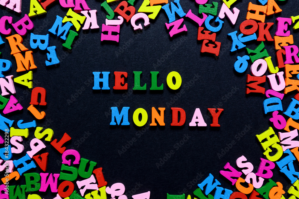 concept design - the word HELLO MONDAY from multi-colored wooden letters on a black background, creative idea concept design - the word HELLO MONDAY from multi-colored wooden letters on a black background, creative idea