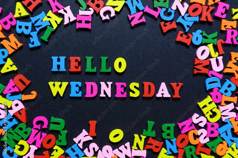 concept design - the word HELLO WEDNESDAY from multi-colored wooden letters on a black background, creative idea concept design - the word HELLO WEDNESDAY from multi-colored wooden letters on a black background, creative idea