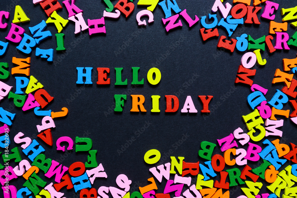 concept design - the word HELLO FRIDAY from multi-colored wooden letters on a black background, creative idea