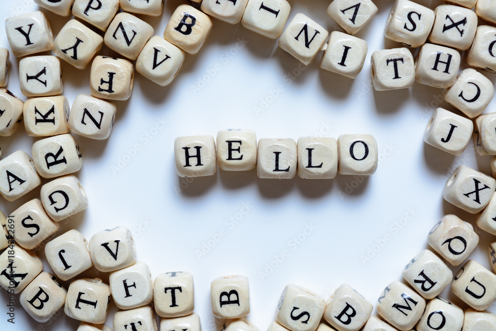 concept design - the word HELLO from wooden letters on a white background, creative idea concept design - the word HELLO from wooden letters on a white background, creative idea