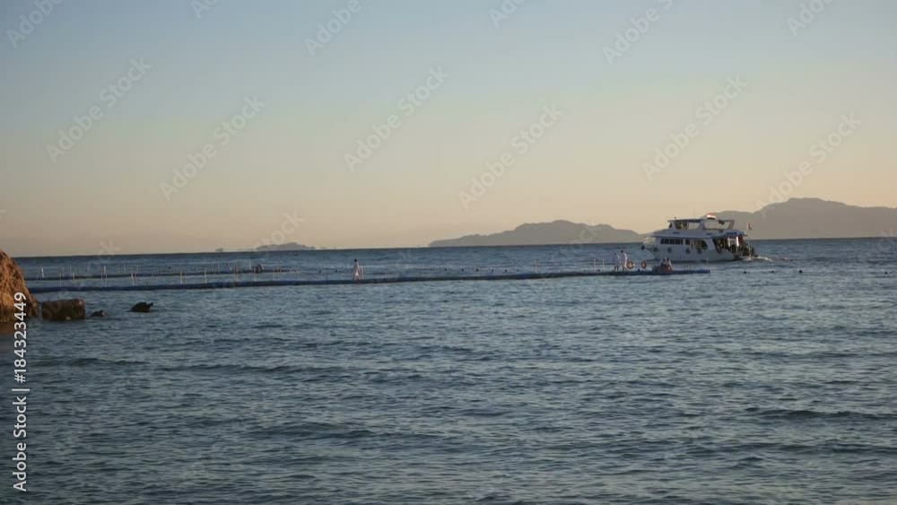 Egypt, Sharm El Sheikh - November, 2017: yacht sails at dawn in the sea Egypt, Sharm El Sheikh - November, 2017: yacht sails at dawn in the sea